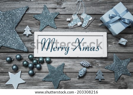 Merry Xmas greeting card with white wooden sign and blue turquoise decoration.