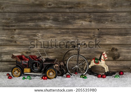 Old antique children toys of wood and tin for christmas decoration on wooden rustic background.