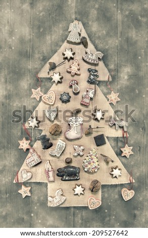 Christmas decoration: wooden carved tree decorated with gingerbread. Shabby chic style in pastel colors.