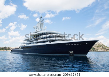 Gigantic big and large luxury mega yacht with helicopter landing place on the blue ocean. Investment for millionaires.
