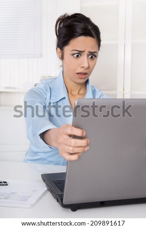 Shocked businesswoman forgotten her password or is victim of computer criminality.