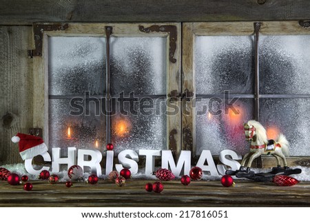 Rustic christmas window with red candles, horse and greeting text.