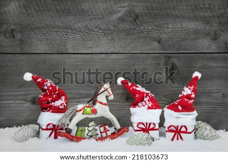 Classical christmas decoration in red, white and green presents on wooden background.