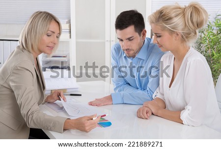 Young couple in a date with a banker or adviser for retirement arrangements.