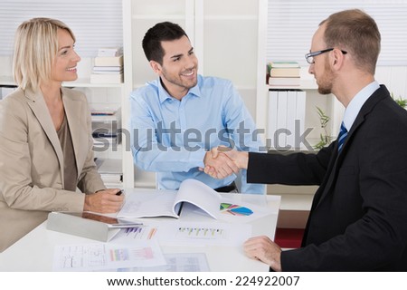 Successful business team sitting around a table in a meeting.