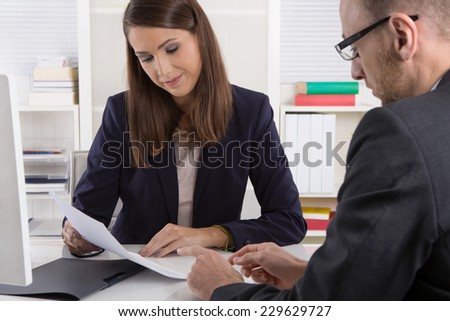 Customer and agent sitting at desk in a meeting or successful collaboration under man and woman in the office.