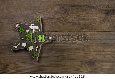 Christmas background with a handmade star of wood and green decoration.