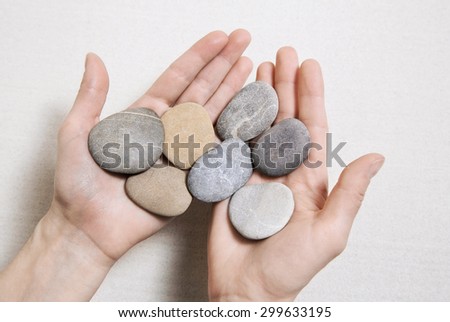 Woman hands holding stones. Concept for balance, combination, life, teamwork and so on.