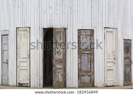 Several old wooden doors, one of them is open