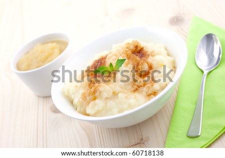 rice pudding and apple puree on table with spoon