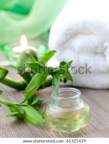 fragrance oil with bamboo, candle and towel
