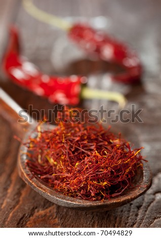 red saffron on wooden spoon closeup