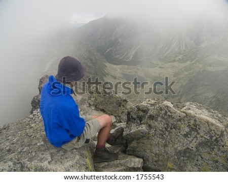 A man looking from the summit down the valley. Tatra Mountains, Slovakia and Poland
