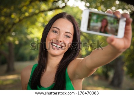 Young beautiful woman shooting self portrait