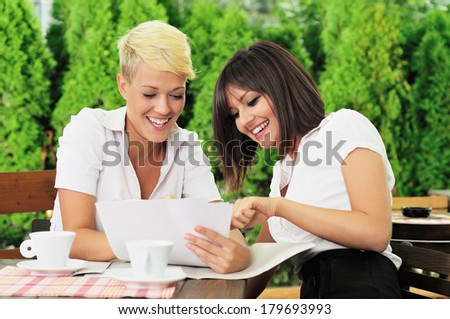 Two women face to face at a business meeting handshaking