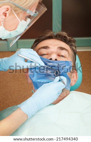 Patient at the dentist with a rubber dam