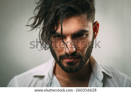 Portrait of a man with a beard and wet face