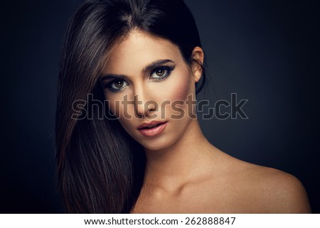 Young woman with straight hair on dark background