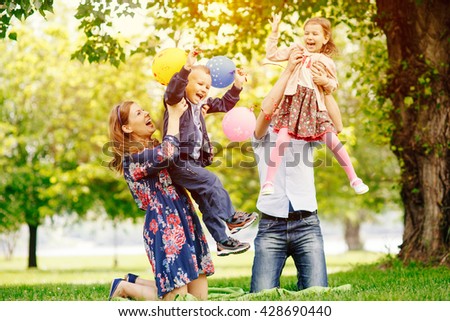 Young happy family having fun in the park