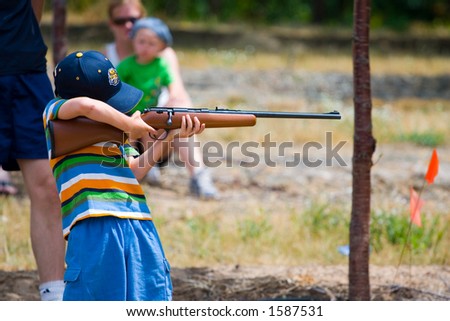boy shooting a rifle