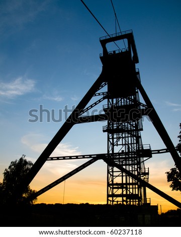 A mine shaft tower at sunset