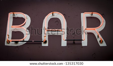 Bar Sign with glowing neon fluorescent letters on old grungy background texture
