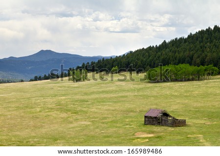Old wooden cabin in a Colordao mountain field