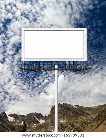 Blank billboard sign in the blue sky above the mountains