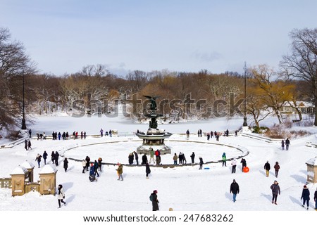 NEW YORK CITY - JANUARY 2015: Crowds of people enjoy the recent snowfall in Central Park after a big winter blizzard hits downtown Manhattan, New York City.