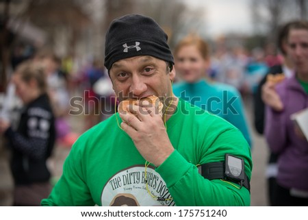 RALEIGH - FEBRUARY 8: The 10th Krispy Kreme Challenge has raised $200.000 for the Children\'s hospital, on February 8, 2014 in Raleigh, USA. The rules are run 2,5 miles, eat 12 donuts and run 2,5 miles