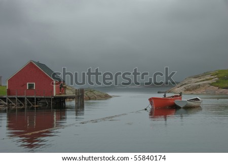 Fisherman\'s Shack with Row boats and approaching rain storm in Peggy\'s Cove