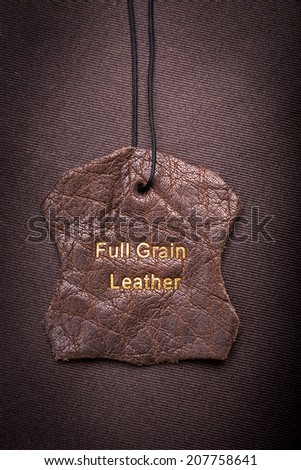 Leather tag with Full Grain Leather text embossed in gold