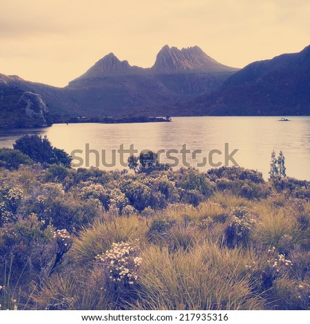 The iconic image of Tasmania, Cradle Mountain sits majestic atop the the jewel that is Dove Lake bathed in glowing sunset light with Instagram style filter