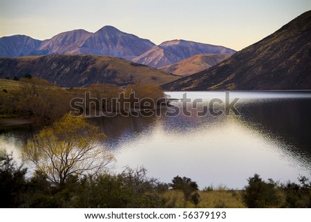 Highland lake with last patches of light giving pastel colours on nearby hills