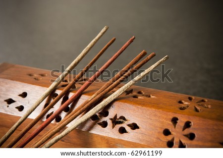 Incense sticks against a timber box