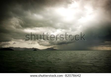 Huge storm clouds with rain over a rough ocean