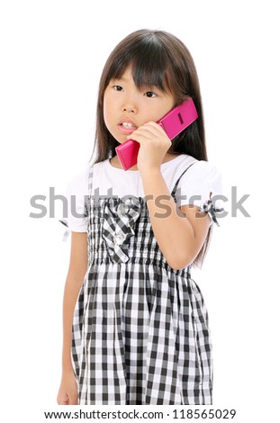 Little girl calling by cellular phone. Sad girl talking on mobile phone