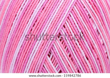 close up pink color thread in spool