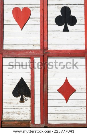 Old wooden door with play card pattern