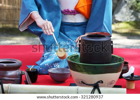 KAGAWA, JAPAN - SEPTEMBER 23, 2015: Japanese woman in traditional kimono prepares the tea ceremony at garden of the Hagiwara Temple on September 23, 2015 in Kagawa Japan.