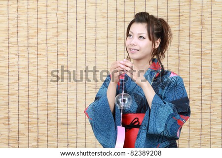 Japanese woman in traditional clothes of Kimono with wind bell