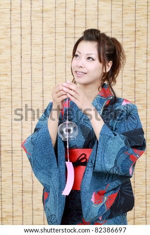 Japanese woman in traditional clothes of Kimono with wind-bell