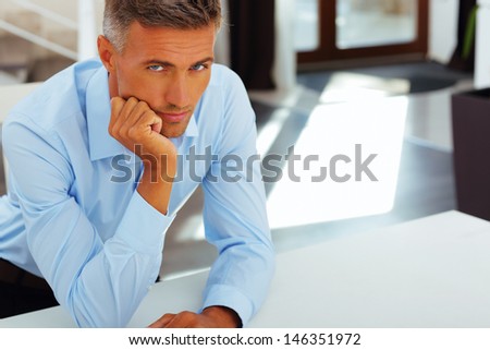 Happy handsome mature man in formal cloths at home