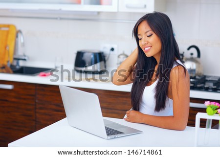 Young beautifu asian woman with laptop at home