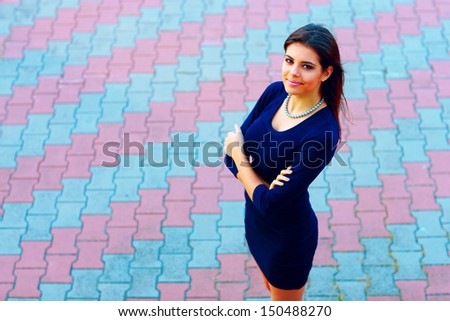 high-angle shot of a happy beautiful businesswoman in formal dress outdoors