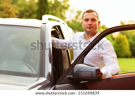 Young caucasian man with his car