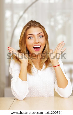 Portrait of a young happy surprised woman