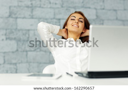 Young happy businesswoman stretching in front of her workplace