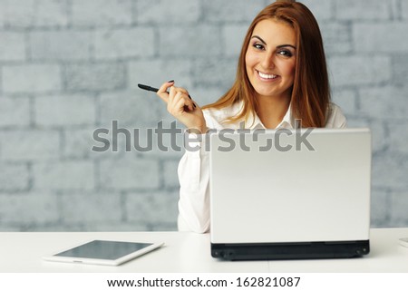 Confident relaxed businesswoman at her workplace in office