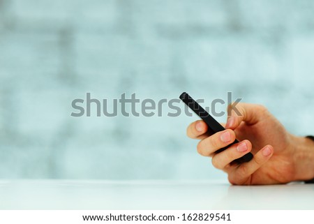 Closeup Image Of A Male Hand Typing On Smartphone